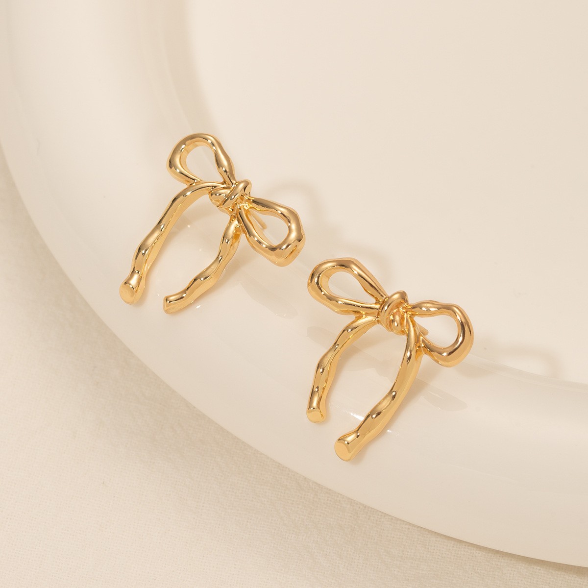 Gold bow ear studs for women minimalist smooth surface earrings